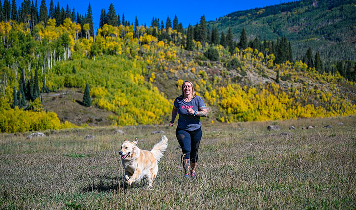 Warrior Angie Peacock jogging with her dog.