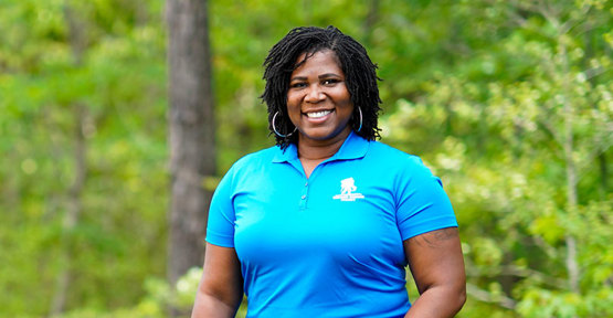Wounded warrior Taniki Richard standing outside and smiling.