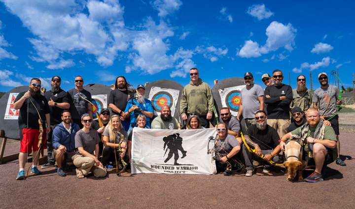 WWP warriors post for a photo during a peer mentor event at an archery range.