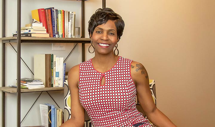 Wounded warrior Tonya Oxendine sits in a chair and smiles.