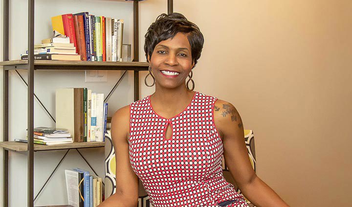 Warrior Tonya Oxendine sits in a chair and smiles.