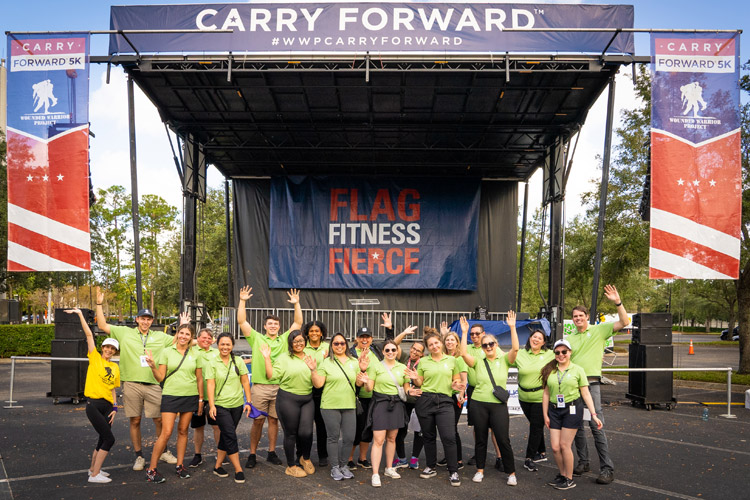 Group of WWP teammates in front of stage at Carry Forward 5K.