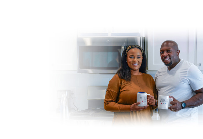 Wounded warrior Melvin Gatewood and his wife, Shalonda, standing in their kitchen drinking coffee.