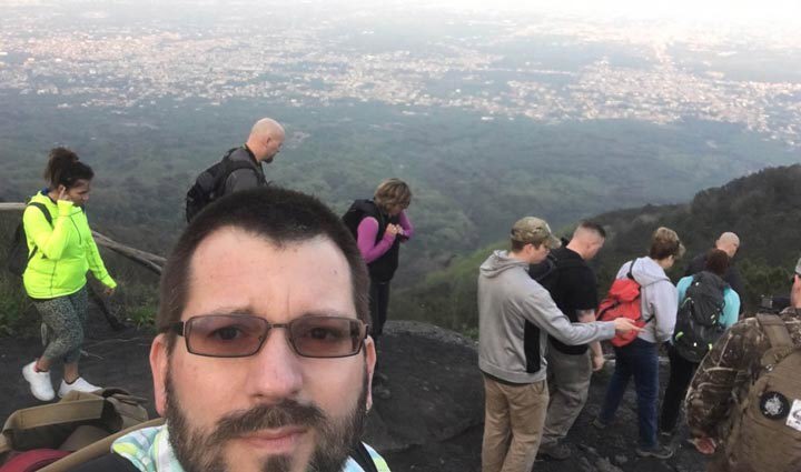 Warrior Steven Swiger takes a selfie with several warriors behind him.