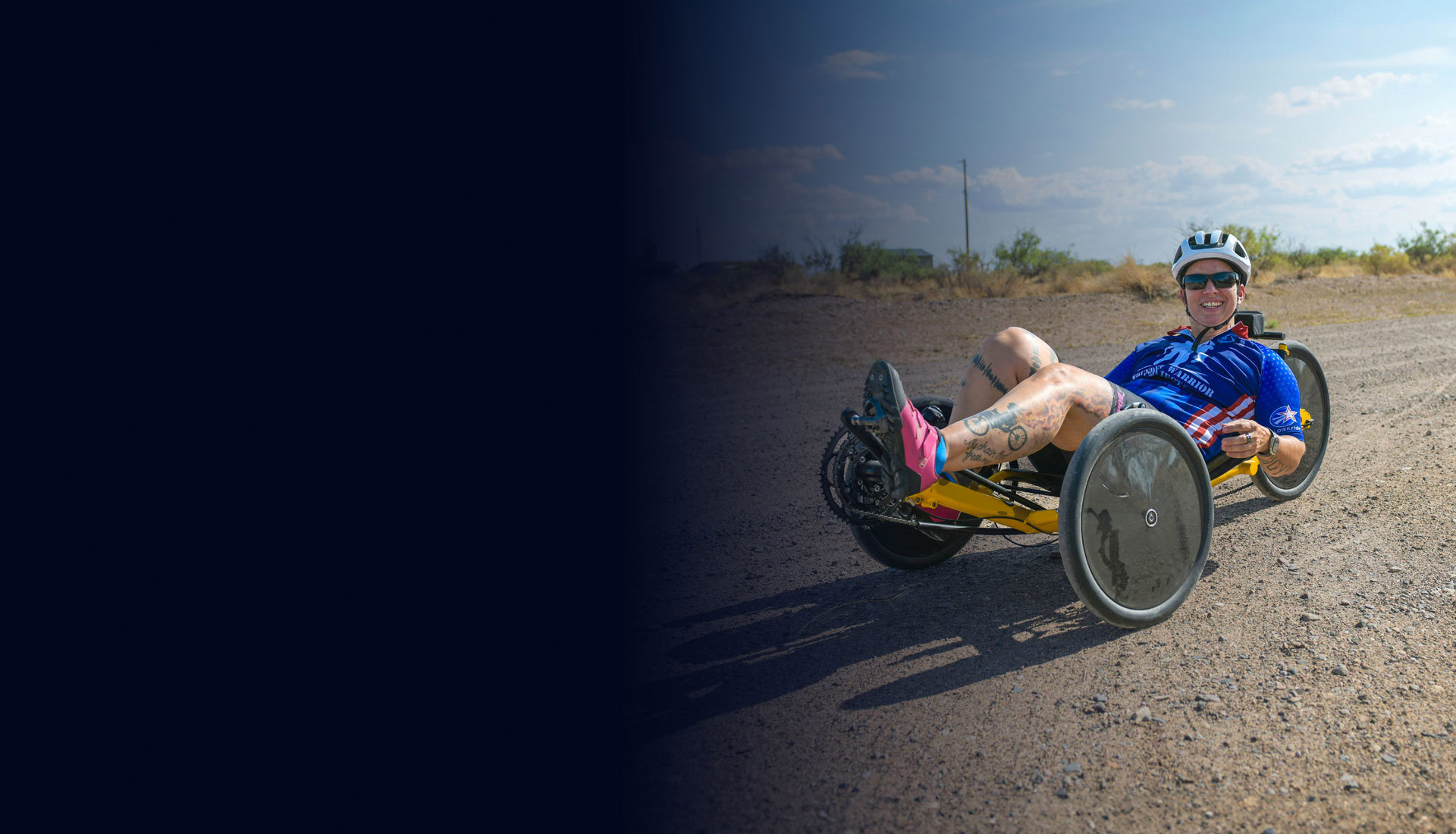 Wounded warrior Beth King trains for Soldier Ride on a recumbent bike on a gravel road.