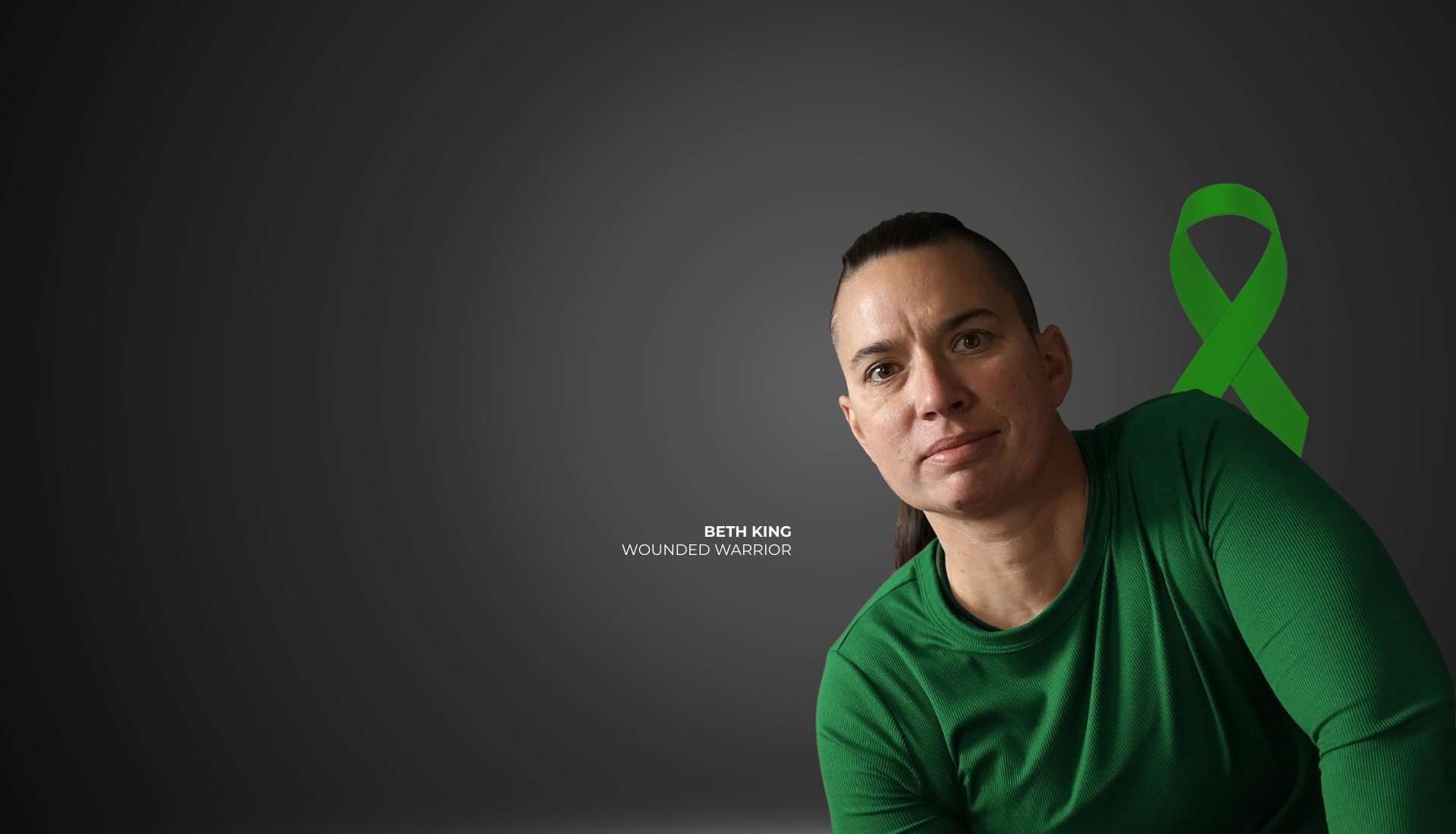 Wounded warrior Beth King in a green shirt sits against a gray background with a green Brain Injury Awareness ribbon.