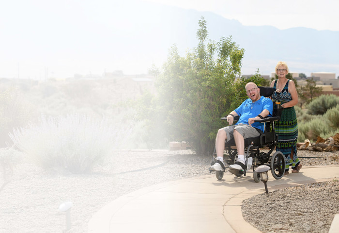 Christine Schei pushes her son wounded warrior Erik Schei, who is seated in his wheelchair